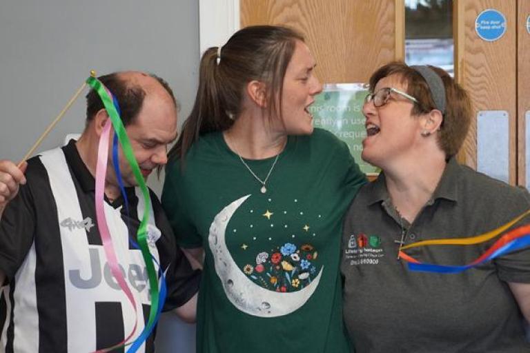 Three music cafe participants enjoying a song together