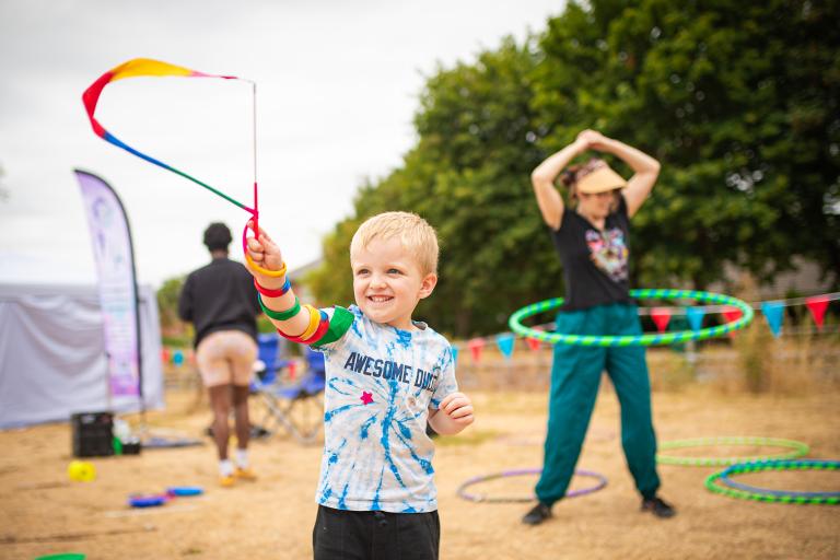 Children playing with hula hoops in an outdoor setting
