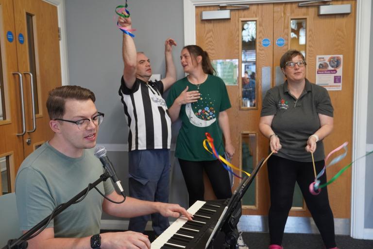 Performers playing alongside a pianist