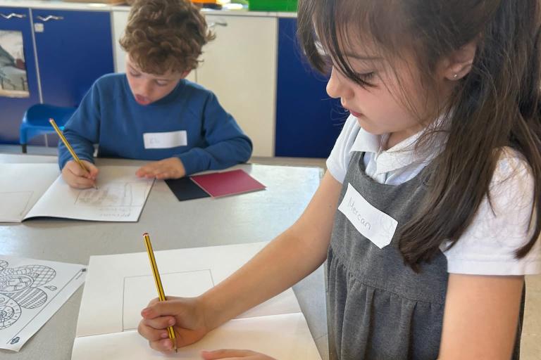 Two children drawing on paper