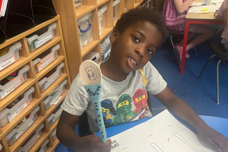 Young person holding a decorated spoon
