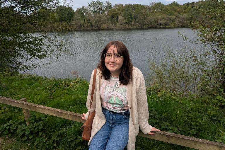 Open Doors team member, Sophie Toyne, resting by a lake