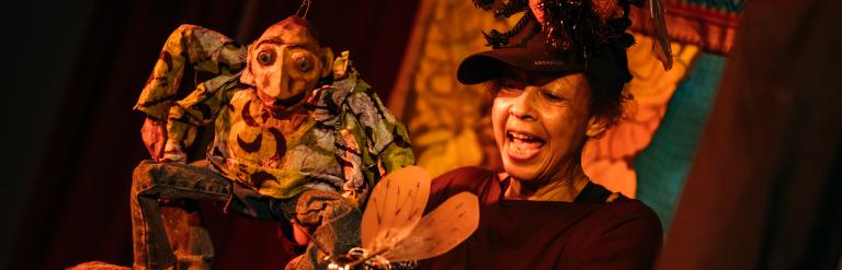 Anansi, the puppet spider, performing on stage